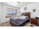 Bedroom featuring a wooden headboard bed, side table, and a window at 17464 Crestview Ct, Monument, CO 80132