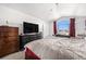 Bedroom with a vaulted ceiling, large window, dresser, and comfortable bed at 17464 Crestview Ct, Monument, CO 80132