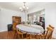 Dining room featuring hardwood floors, seating for six, and adjacent to an open living space at 17464 Crestview Ct, Monument, CO 80132