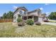 Two story home with neutral color scheme, brick accents, and a well maintained lawn and garden at 17464 Crestview Ct, Monument, CO 80132