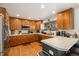 Well-lit kitchen featuring stainless steel appliances, tile countertops, and ample cabinet space at 17464 Crestview Ct, Monument, CO 80132