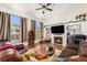 Cozy living room with hardwood floors, a fireplace, and large windows at 17464 Crestview Ct, Monument, CO 80132