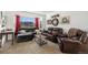 Spacious living room features a large window, leather furniture, and tasteful decor at 17464 Crestview Ct, Monument, CO 80132