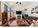 Bright living room with a fireplace, built-in shelves, and large windows for natural light at 17464 Crestview Ct, Monument, CO 80132
