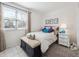 Bedroom with a bed, a bench, and a large window at 7344 S Sheephorn Mtn, Littleton, CO 80127