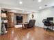 Basement with a comfortable chair, a TV, and laminate floors at 7344 S Sheephorn Mtn, Littleton, CO 80127