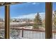 Balcony view showcasing the surrounding snowy landscape, trees, and a mountain backdrop at 1901 Blue Mountain Ave, Berthoud, CO 80513