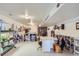 Spacious basement with white walls and flooring, a storage unit, and crafting/sewing tables at 1901 Blue Mountain Ave, Berthoud, CO 80513