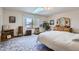 Bright bedroom is enhanced by a skylight and features ample space and natural wood furnishings at 1901 Blue Mountain Ave, Berthoud, CO 80513