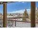A view from the deck, with an outdoor table and chairs set and a snowy mountainscape in the distance at 1901 Blue Mountain Ave, Berthoud, CO 80513