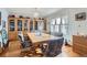 Traditional dining room featuring a large wooden table, patterned chairs, and built-in display cabinets at 1901 Blue Mountain Ave, Berthoud, CO 80513