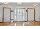 Entryway featuring wood floors, white walls, and a decorative glass door with white trim at 1901 Blue Mountain Ave, Berthoud, CO 80513