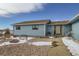 Exterior of a light-blue home with a gravel firepit, stone walkway, and well-maintained landscaping at 1901 Blue Mountain Ave, Berthoud, CO 80513