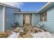 Charming single-story home with light blue siding, featuring a covered front porch with outdoor seating at 1901 Blue Mountain Ave, Berthoud, CO 80513