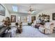 Cozy living room with comfortable seating, large windows, skylights, and decorative bookshelves at 1901 Blue Mountain Ave, Berthoud, CO 80513
