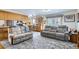 Cozy living room showcases comfortable seating and an open layout to the kitchen and outdoor access at 1901 Blue Mountain Ave, Berthoud, CO 80513