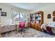 Craft room features a sewing machine, desk, and large window, suitable for creative work at 1901 Blue Mountain Ave, Berthoud, CO 80513