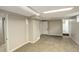 Open basement area with carpet flooring and white trim at 1925 Syracuse St, Denver, CO 80220