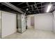 Basement utility area with tile flooring, exposed ceiling, and mechanical equipment at 1925 Syracuse St, Denver, CO 80220