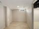 Finished basement room with tile flooring, a small window for natural light, and neutral paint at 1925 Syracuse St, Denver, CO 80220