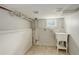 Basement utility room features a wash basin, tile floor, and exposed piping at 1925 Syracuse St, Denver, CO 80220