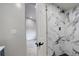Modern bathroom featuring stylish marble tiling in shower and sleek fixtures at 1925 Syracuse St, Denver, CO 80220