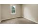Bedroom with neutral walls, carpet, and window with exterior view at 1925 Syracuse St, Denver, CO 80220