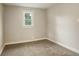 Bedroom with neutral walls, carpet, and bright window at 1925 Syracuse St, Denver, CO 80220