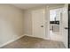 Bedroom featuring neutral walls, carpet and open door to kitchen at 1925 Syracuse St, Denver, CO 80220