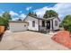 Charming home with white siding, black trim, and a concrete driveway at 1925 Syracuse St, Denver, CO 80220
