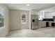 Kitchen open to the living space, stainless steel appliances, and light wood flooring at 1925 Syracuse St, Denver, CO 80220