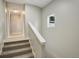 Staircase with carpet treads and white handrail at 1925 Syracuse St, Denver, CO 80220