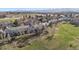 Aerial view of residential area with multi-story homes, mature trees, and a landscaped community at 9659 W Cornell Pl, Lakewood, CO 80227