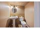Bathroom with a pedestal sink, a toilet, and a neutral color scheme at 9659 W Cornell Pl, Lakewood, CO 80227