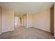 Bedroom showcasing neutral walls, plush carpeting and an adjacent hallway to the closet and bathroom at 9659 W Cornell Pl, Lakewood, CO 80227