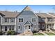 Charming townhome with eye-catching blue facade, stylish trim, and inviting entrance at 9659 W Cornell Pl, Lakewood, CO 80227