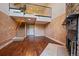 Inviting living space with stone fireplace, hardwood floors, and open staircase at 9659 W Cornell Pl, Lakewood, CO 80227