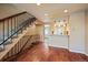 Inviting living area featuring hardwood floors, a staircase, and kitchen access at 9659 W Cornell Pl, Lakewood, CO 80227
