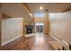Cozy living space featuring a stone fireplace, hardwood floors, and natural light at 9659 W Cornell Pl, Lakewood, CO 80227