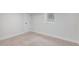 Finished basement bedroom featuring neutral carpet, base molding and a window at 2659 Ash St, Denver, CO 80207