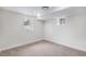 Finished basement with neutral carpet, base molding, and two windows at 2659 Ash St, Denver, CO 80207