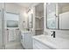 Modern bathroom with double sink, quartz countertops, and a walk-in closet at 2659 Ash St, Denver, CO 80207
