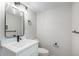 Small bathroom with a vanity, quartz countertop, and classic lighting fixtures at 2659 Ash St, Denver, CO 80207