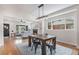 Open floor plan with dining area, hardwood floors, and access to the living room and kitchen at 2659 Ash St, Denver, CO 80207