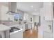 Modern kitchen with white cabinets, stainless steel appliances, and open layout to dining area at 2659 Ash St, Denver, CO 80207