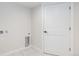 Laundry area featuring tile floors, a white door and hookups for a washer and dryer at 2659 Ash St, Denver, CO 80207