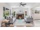 Bright living room features a brick fireplace, hardwood floors, and neutral decor at 2659 Ash St, Denver, CO 80207