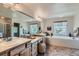 Large bathroom offers a soaking tub, shower and dual sink vanity with lots of natural light at 13962 Dexter Way, Thornton, CO 80602