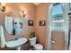 Charming powder room with pedestal sink, decorative lighting, and natural light at 13962 Dexter Way, Thornton, CO 80602