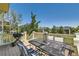 Outdoor deck featuring dining and seating area, with picturesque backyard views at 13962 Dexter Way, Thornton, CO 80602